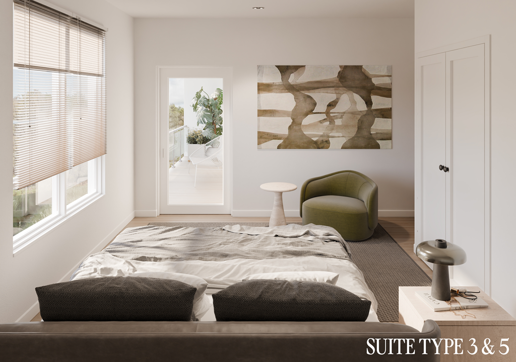 A bedroom with a bed, a green chair, and a painting on the wall.