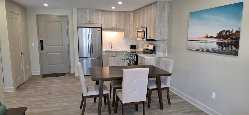 A dining room with a wooden table and chairs.