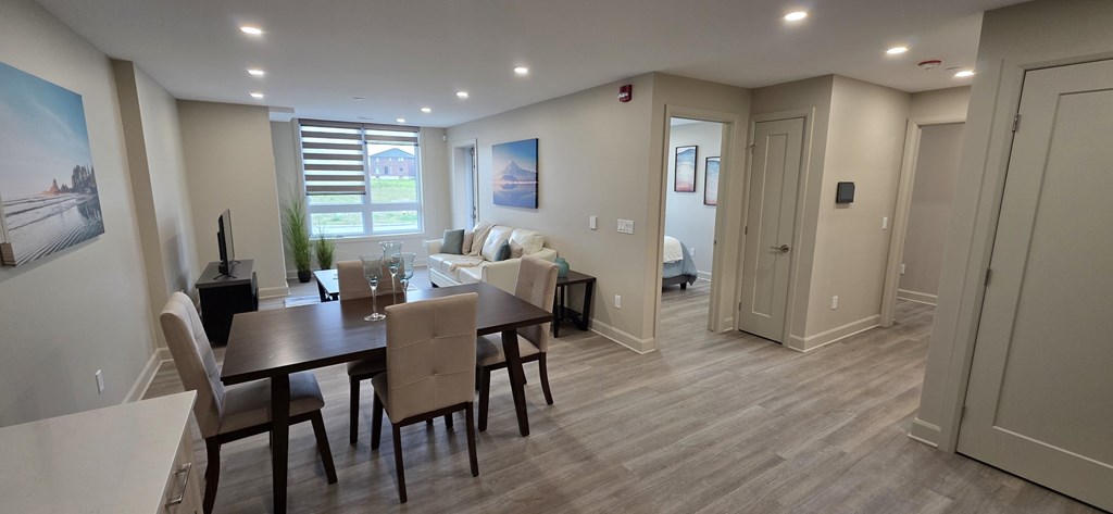 A dining room with a table and chairs.