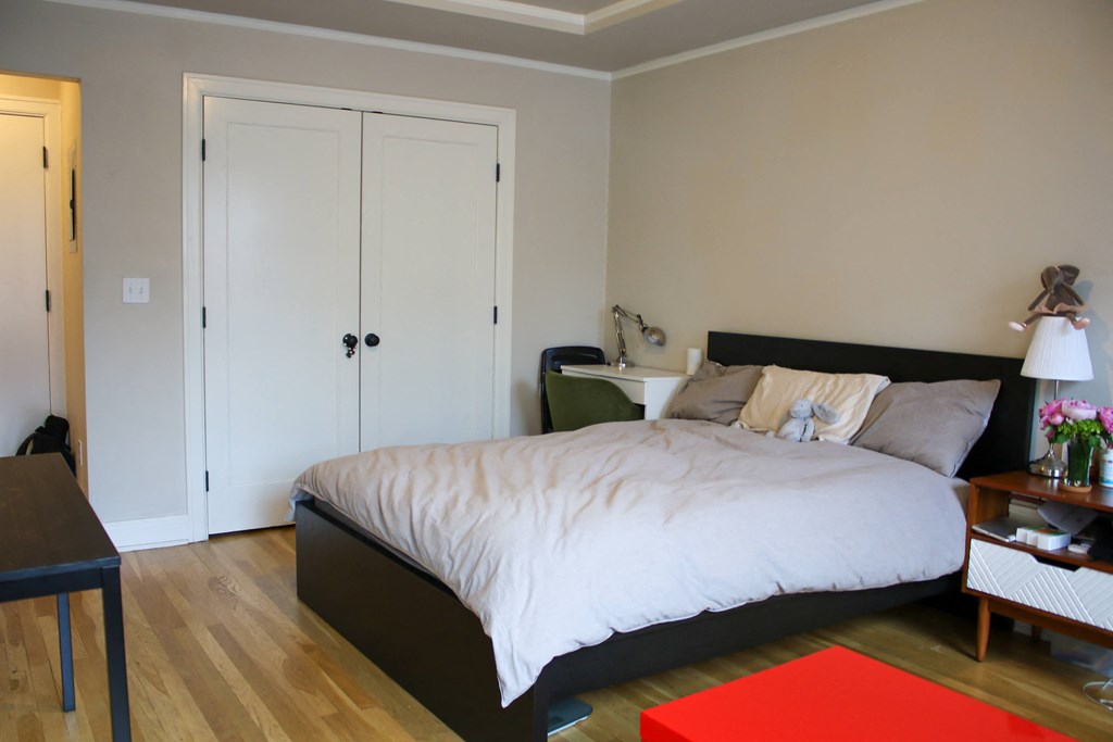 a bedroom with a bed and two closet doors