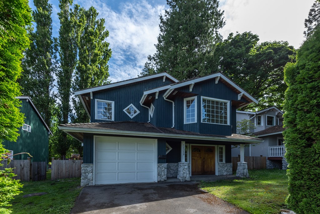 a house with a blue siding and a white garage door