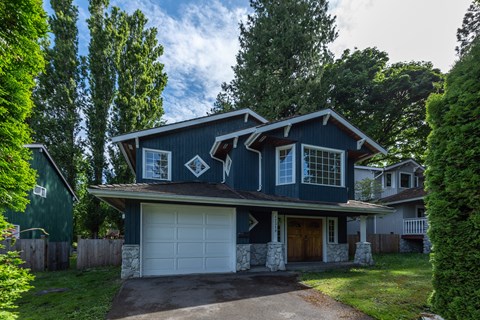 a house with a blue exterior and a white garage door