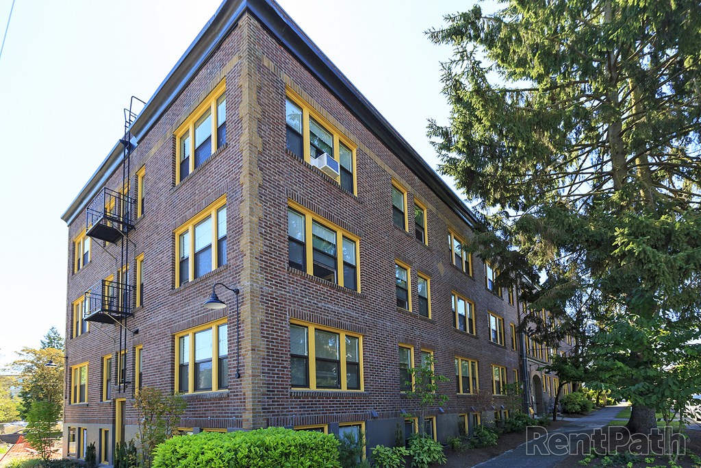 a red brick apartment building with yellow and black windows