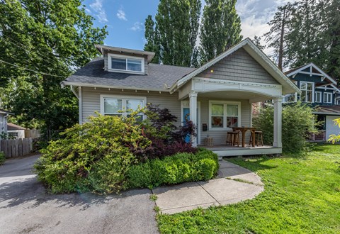A house with a grey roof and a small porch.
