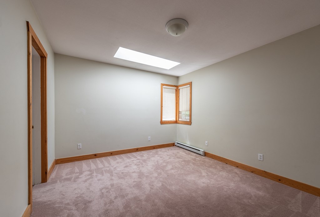 an empty room with a window and a door