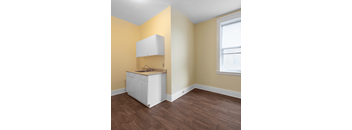 A kitchen with a white cabinet and sink.
