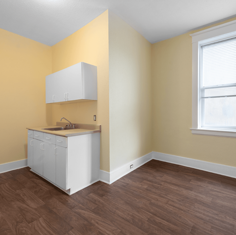 A kitchen with a white cabinet and sink.