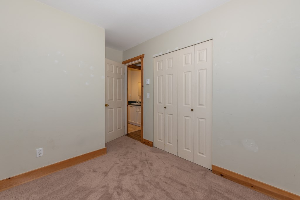 a bedroom with two closets and a door to a bathroom