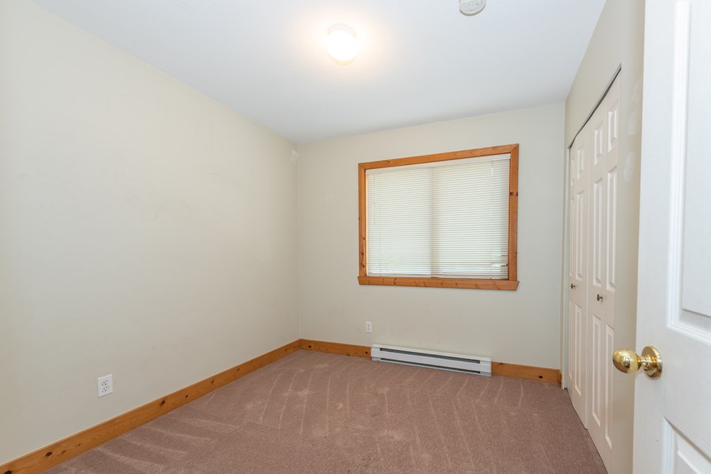 a bedroom with a window and a door