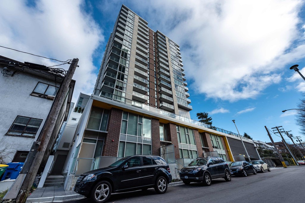 an apartment building with cars parked in front of it