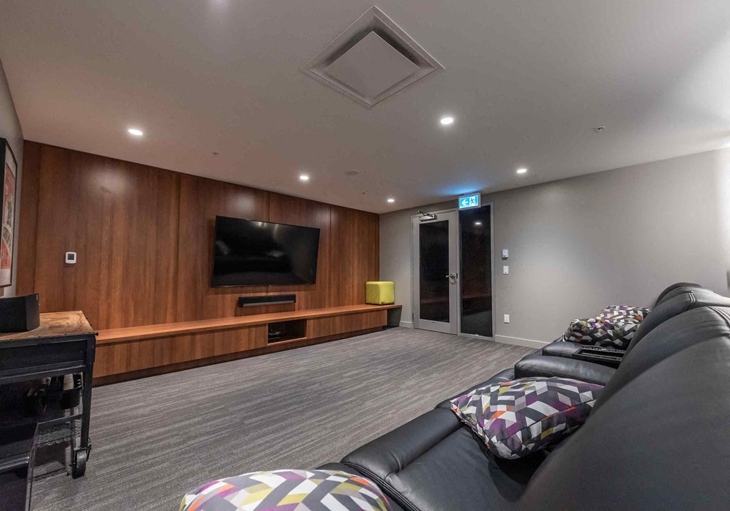 a large living room with a couch and a tv