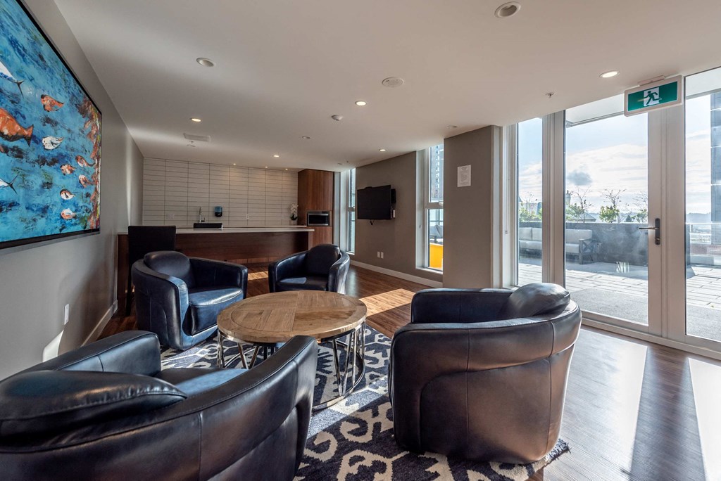 a living room with leather chairs and a table
