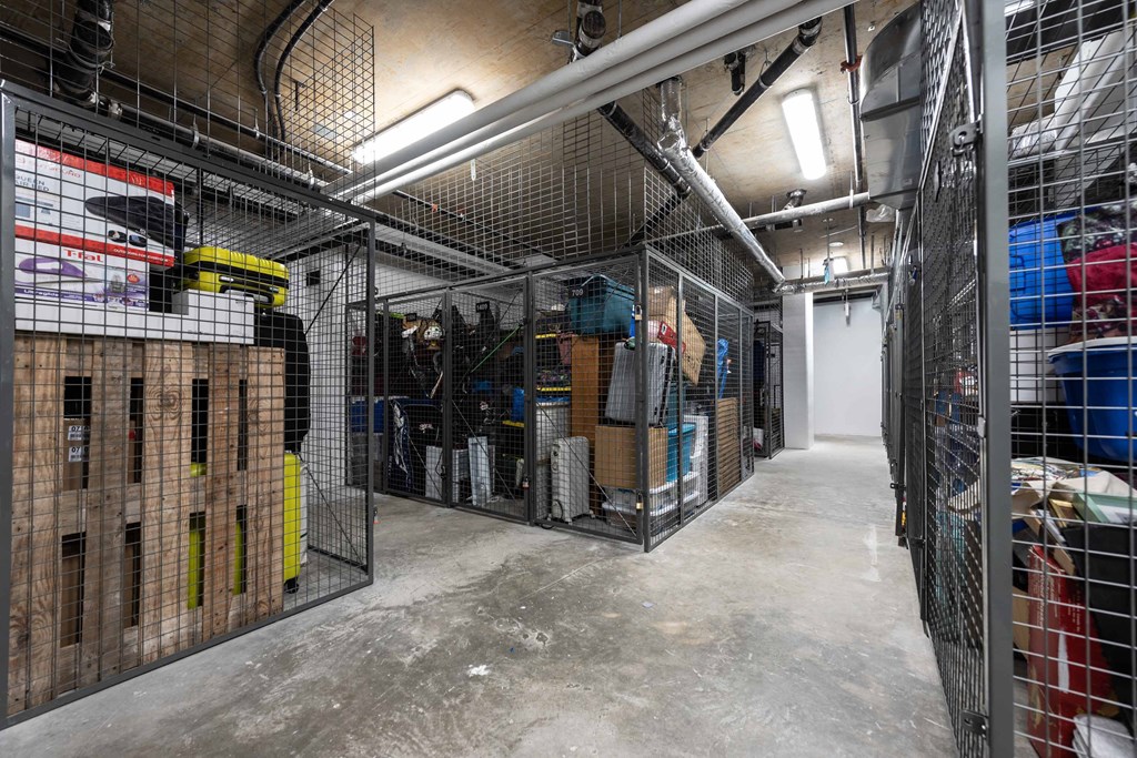 a large storage room filled with boxes and wire cages