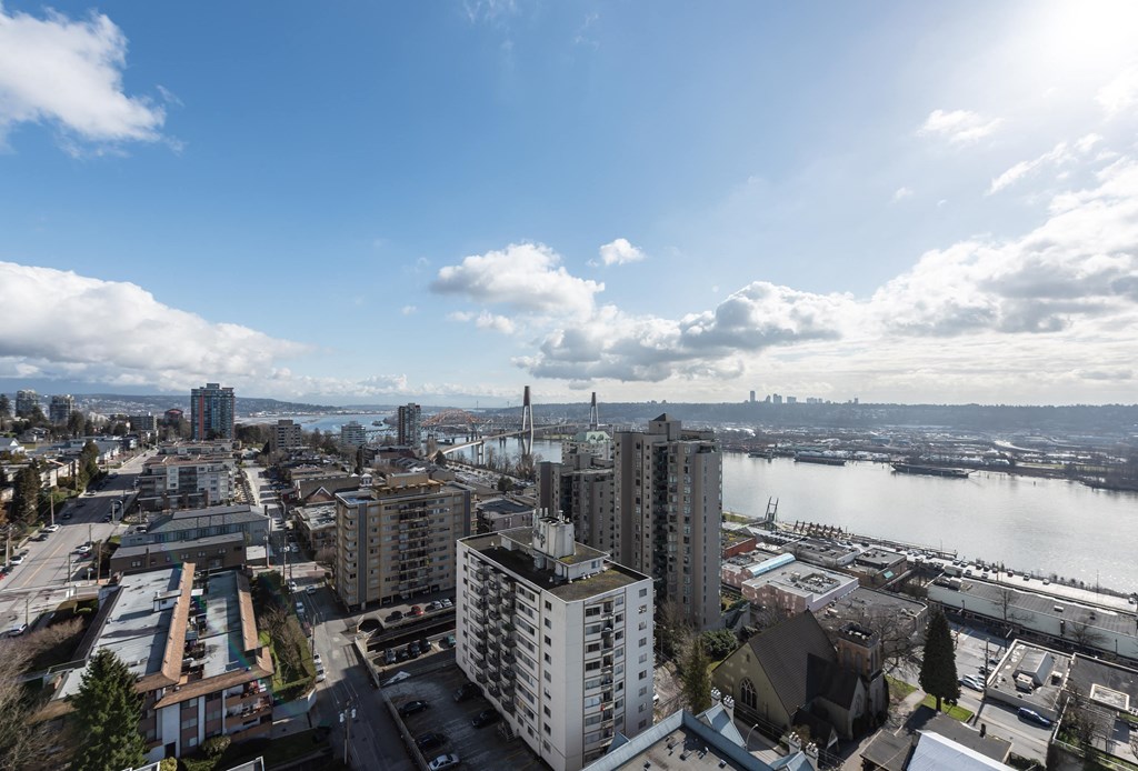 an aerial view of the city with a lake and buildings