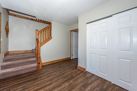 a bedroom with a staircase and a door