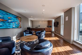 a living room with leather chairs and a table