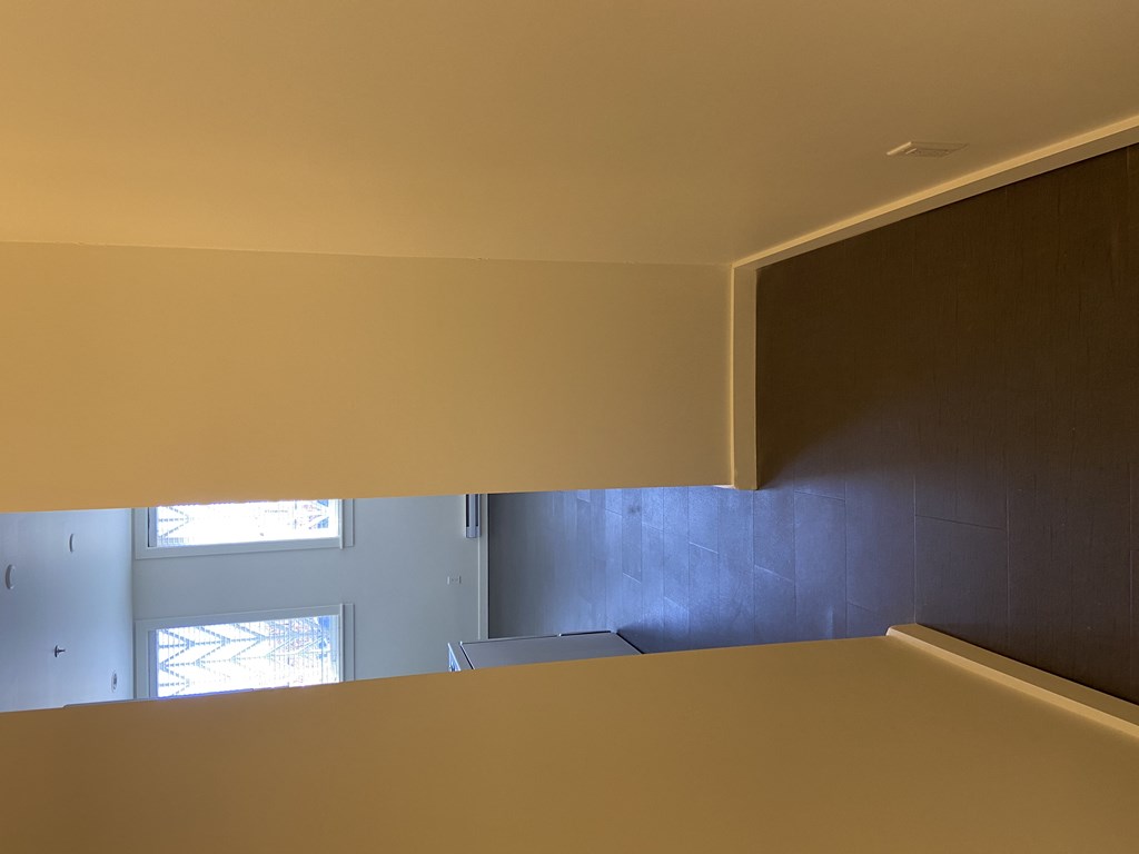 a view from the bottom of the stairs looking up to the second floor