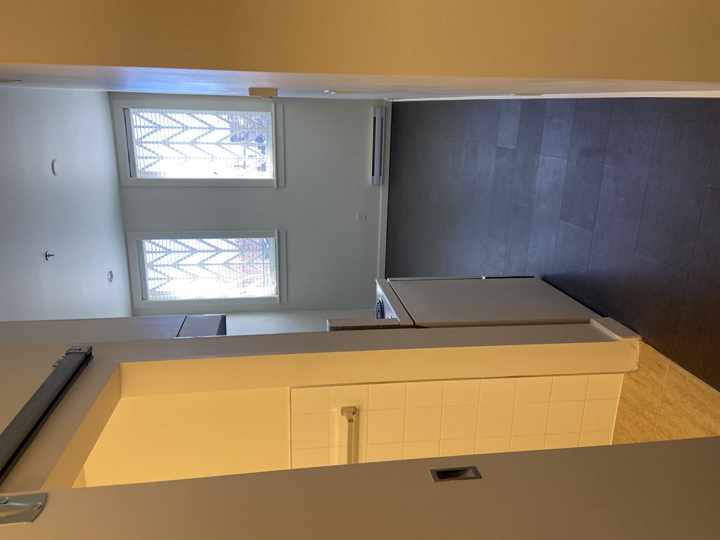 a view of the kitchen from the top of the stairs