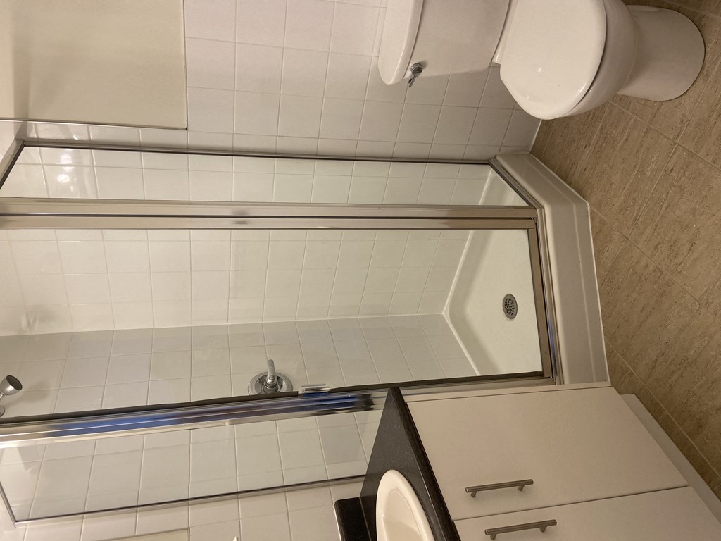 a small bathroom with a bathtub and a washer and dryer