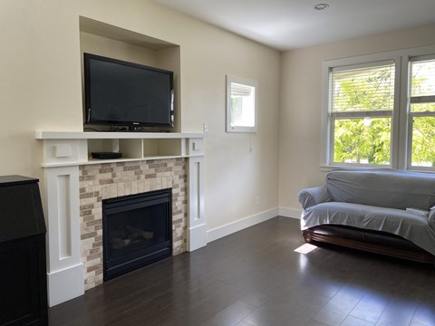 A living room with a fireplace and a television on top of it.