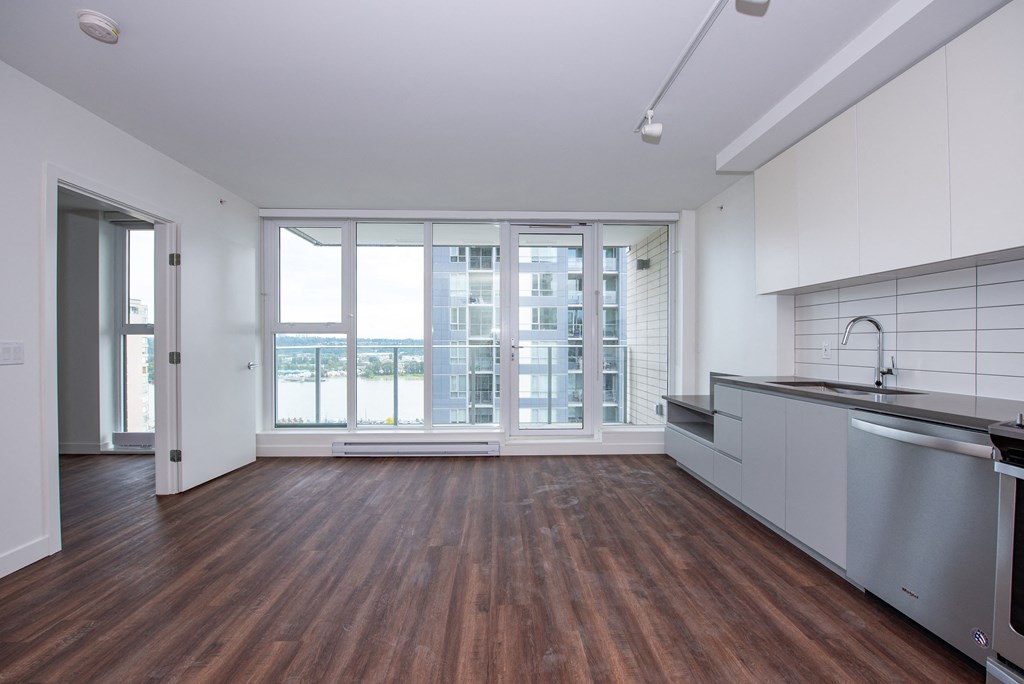 an open kitchen and living room in a 555 waverly unit