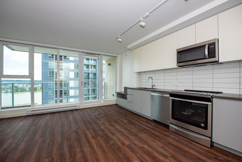 a kitchen with white cabinets and stainless steel appliances