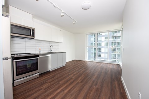 A kitchen with a stove top oven and a microwave.