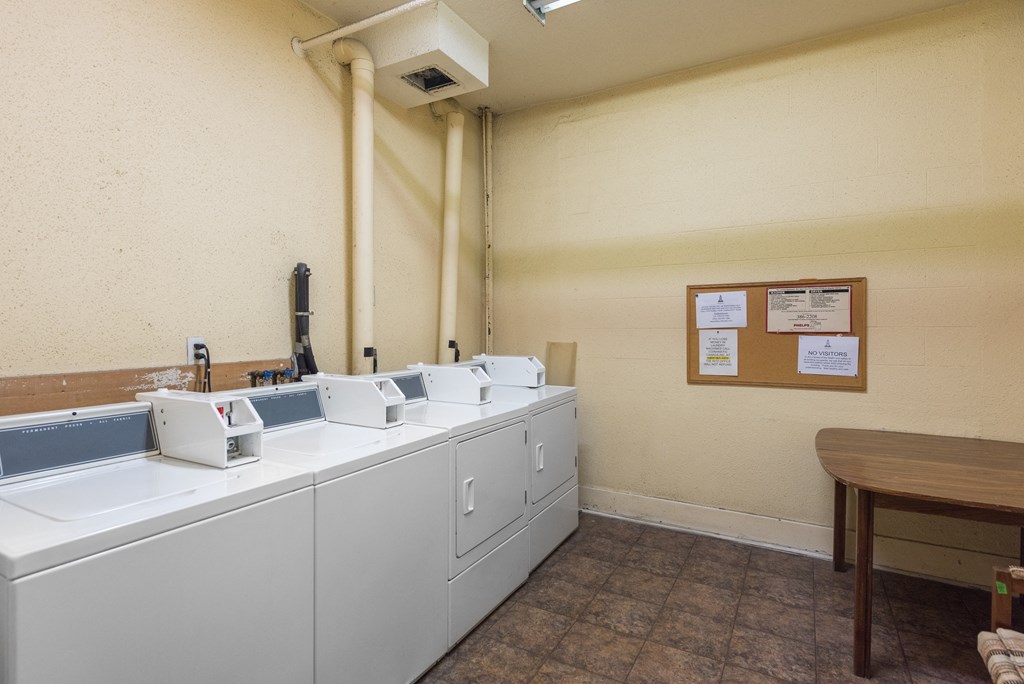a laundry room with washers and dryers