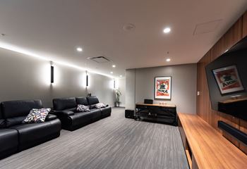a large living room with leather couches and a tv