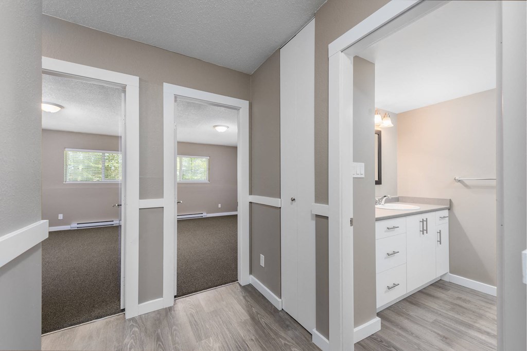 A room with white walls and a brown carpet.
