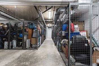 a room filled with cages and boxes in a warehouse