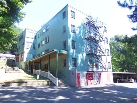 A multi-story building with a fire escape on the side.