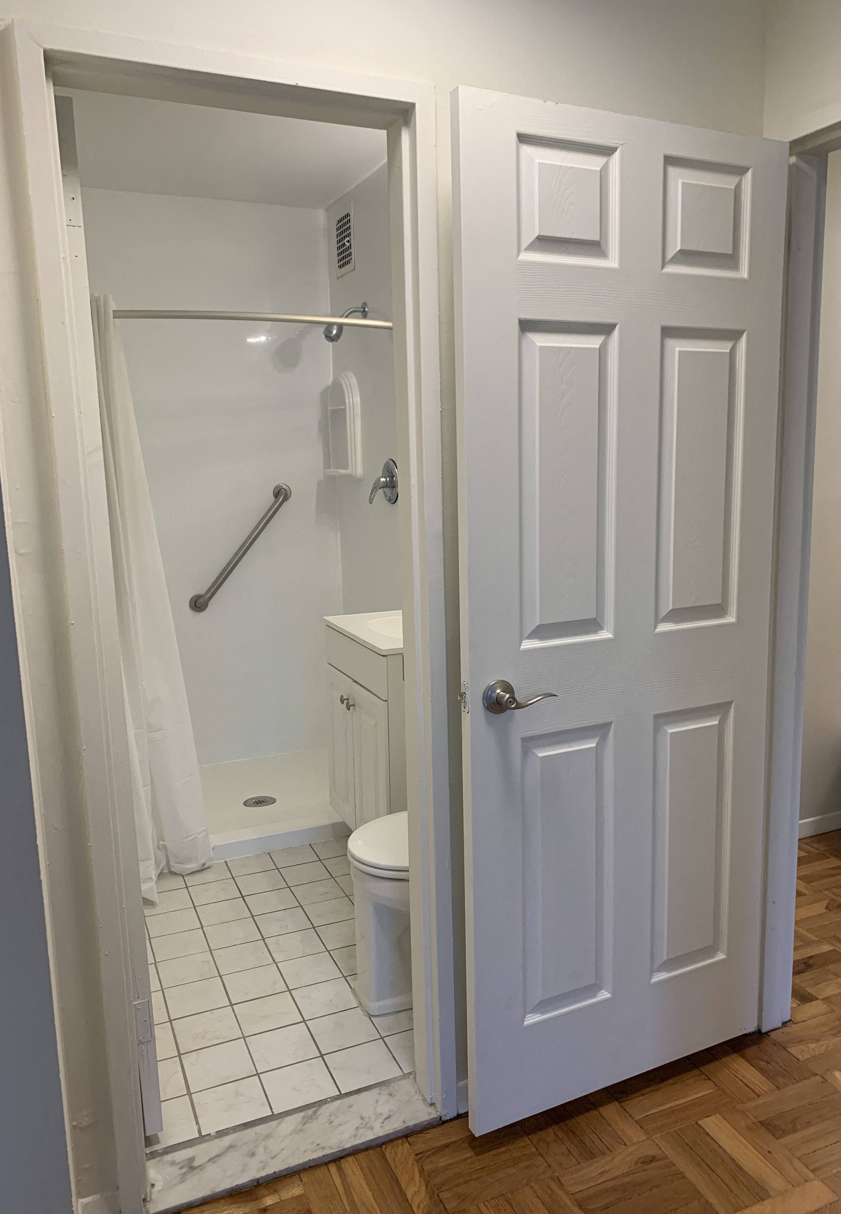 a small bathroom with a shower and a toilet