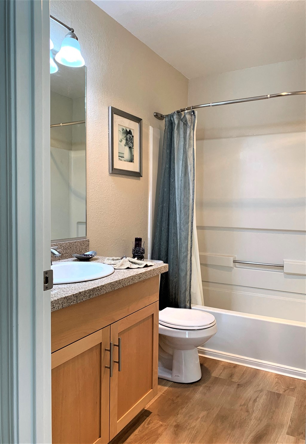 2 bedroom model guest bathroom in hallway 
toilet, shower/bath tub, sink with granite/ quartz counter top