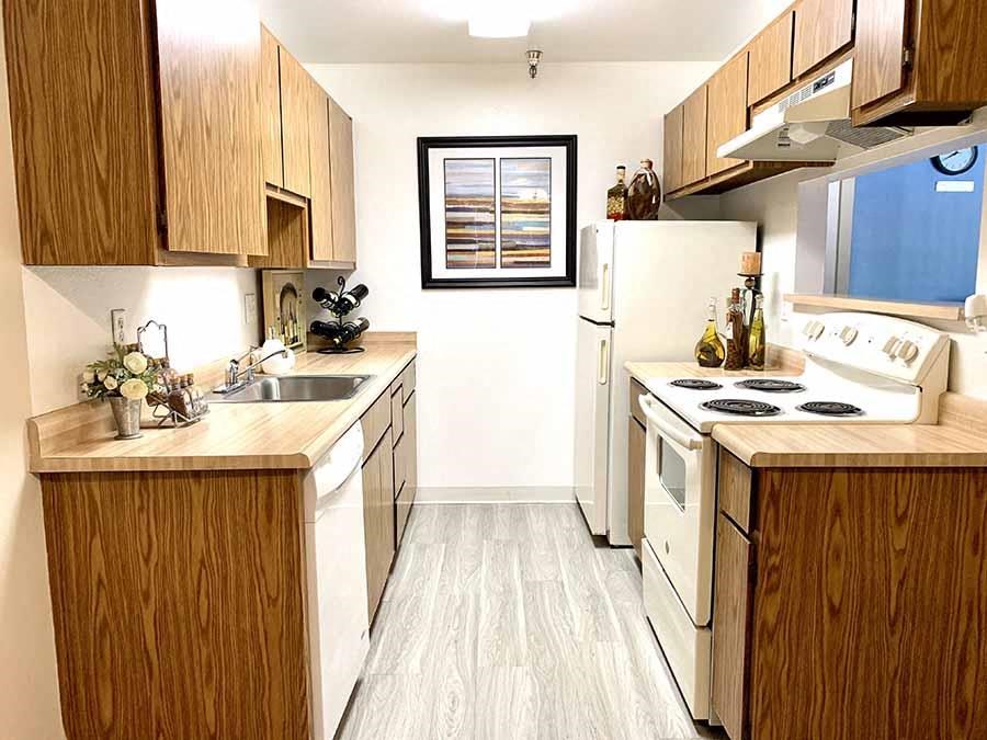 a kitchen with white appliances and wooden cabinets