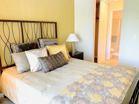 a bedroom with a large bed with pillows on it