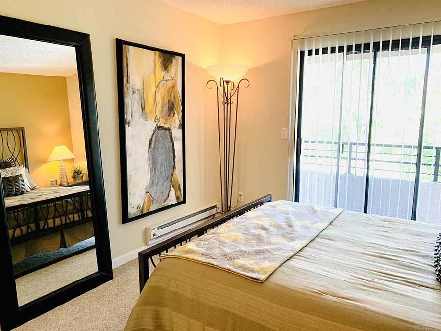 a bedroom with a large bed and a large window