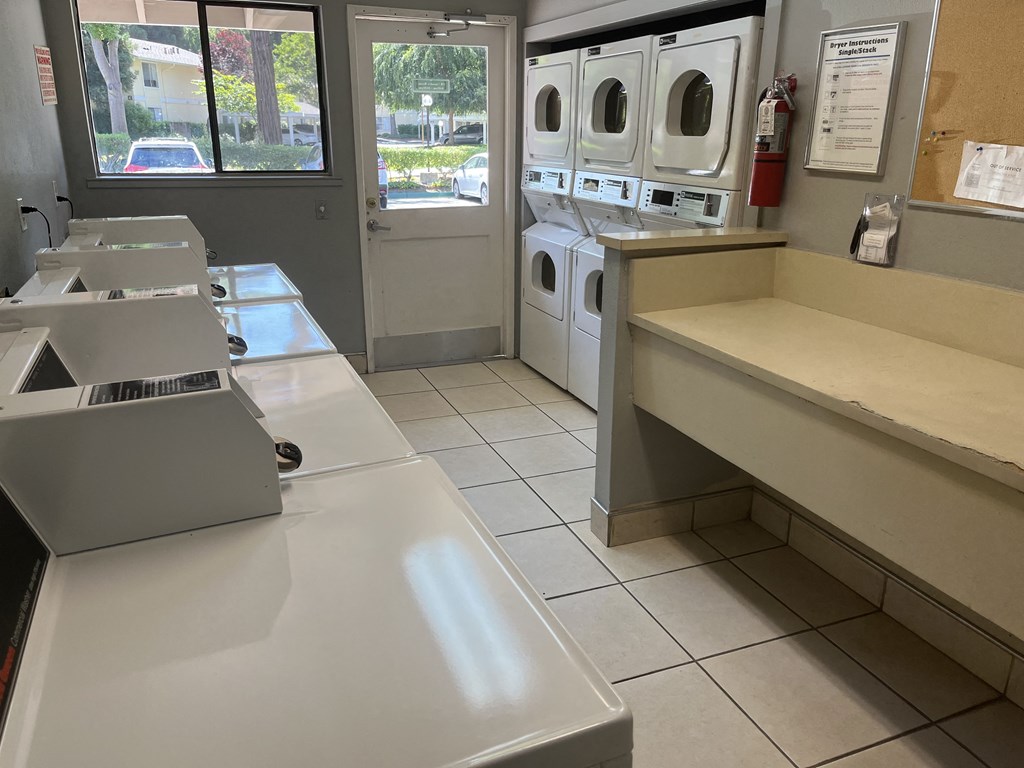 a laundry room with washers and dryers