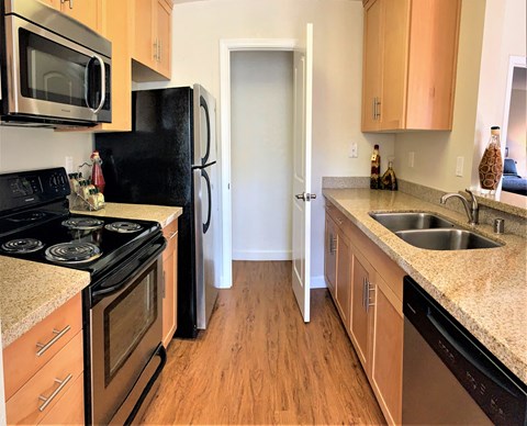 a kitchen with stainless steel appliances and granite counter tops