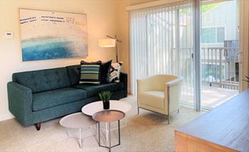 one bedroom model with carpet, living room, couch, accent chair, 3 tired coffee table - Photo Gallery 2