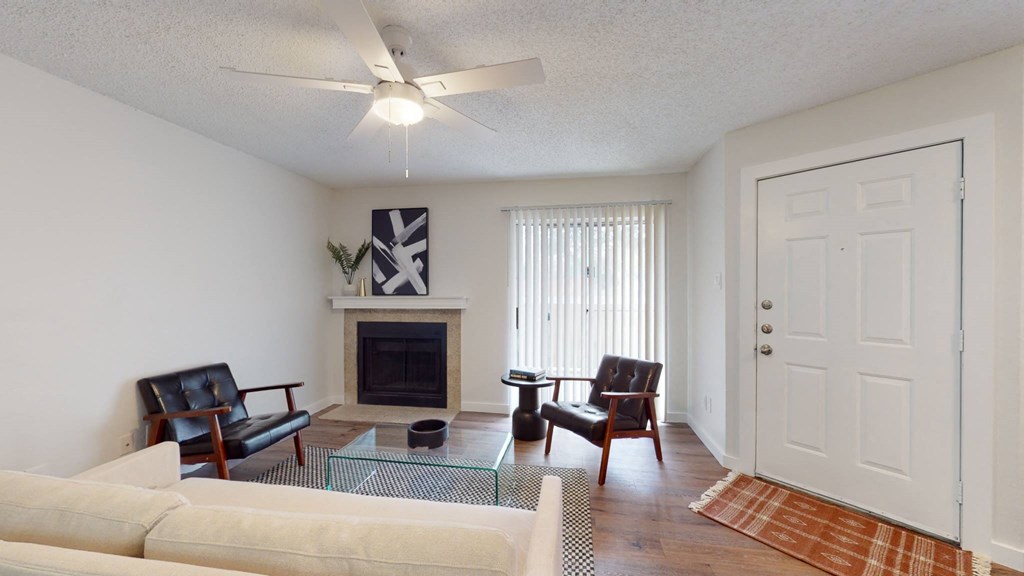 a living room with a couch and chairs and a fireplace