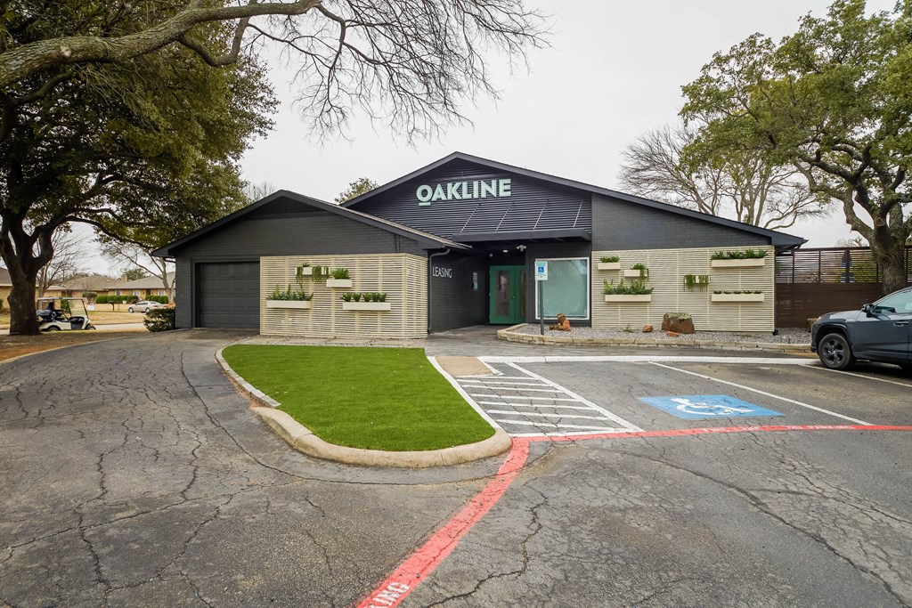 A building with the word "OAKLINE" on it is surrounded by a parking lot.