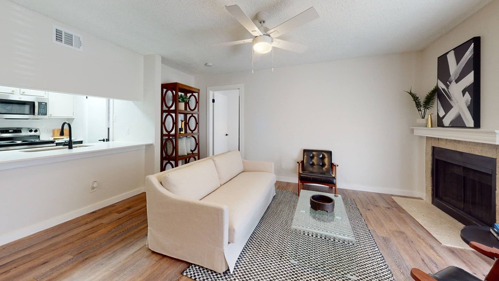 a living room with a couch and a ceiling fan