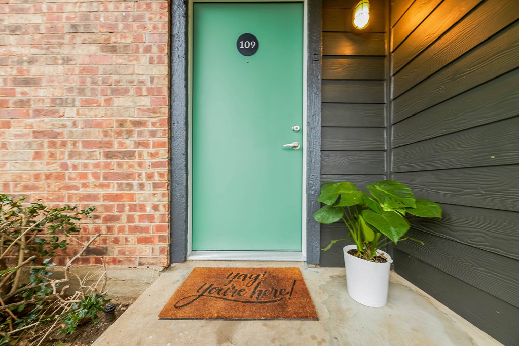 A green door with a number 109 on it.