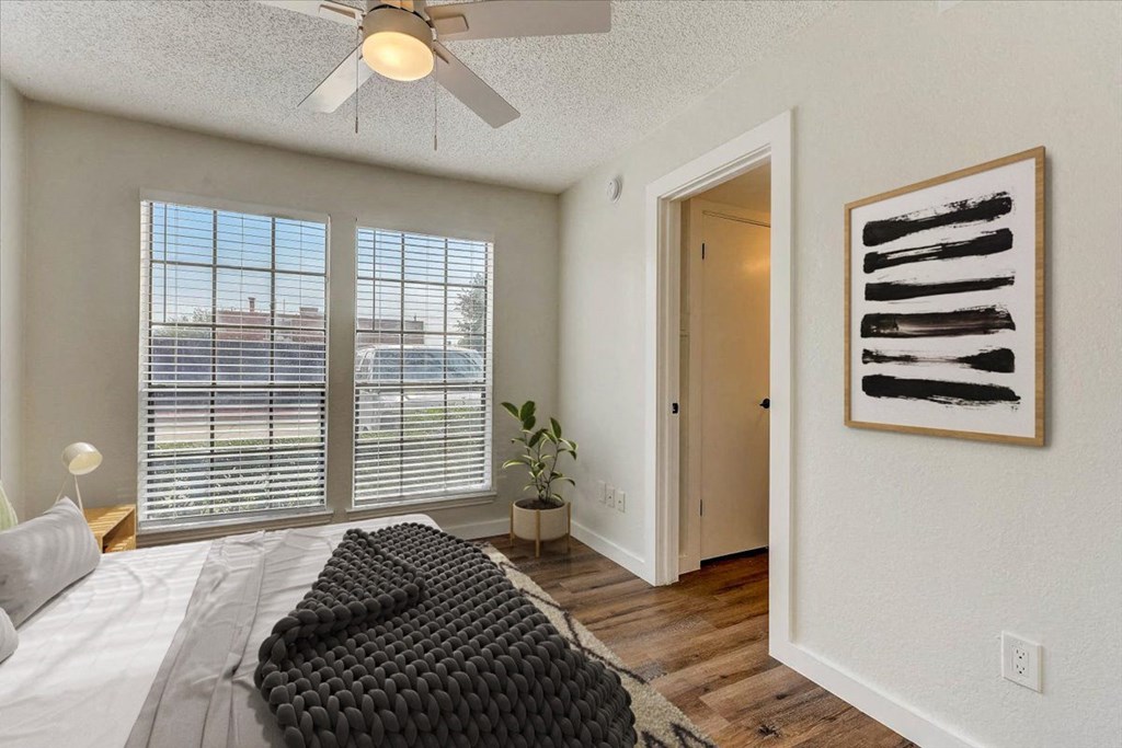 a bedroom with a large bed and a ceiling fan