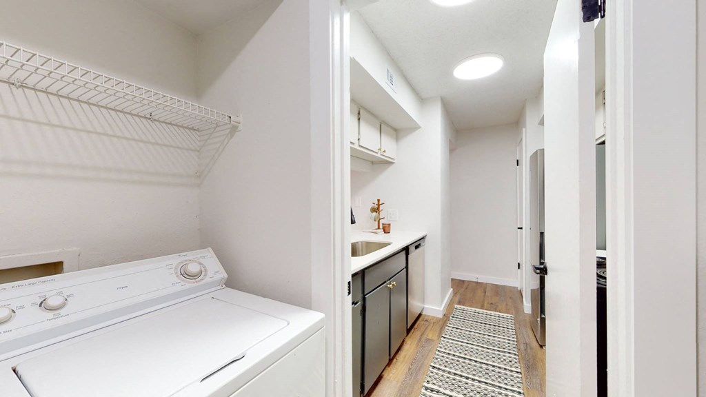 an empty laundry room with a washer and dryer
