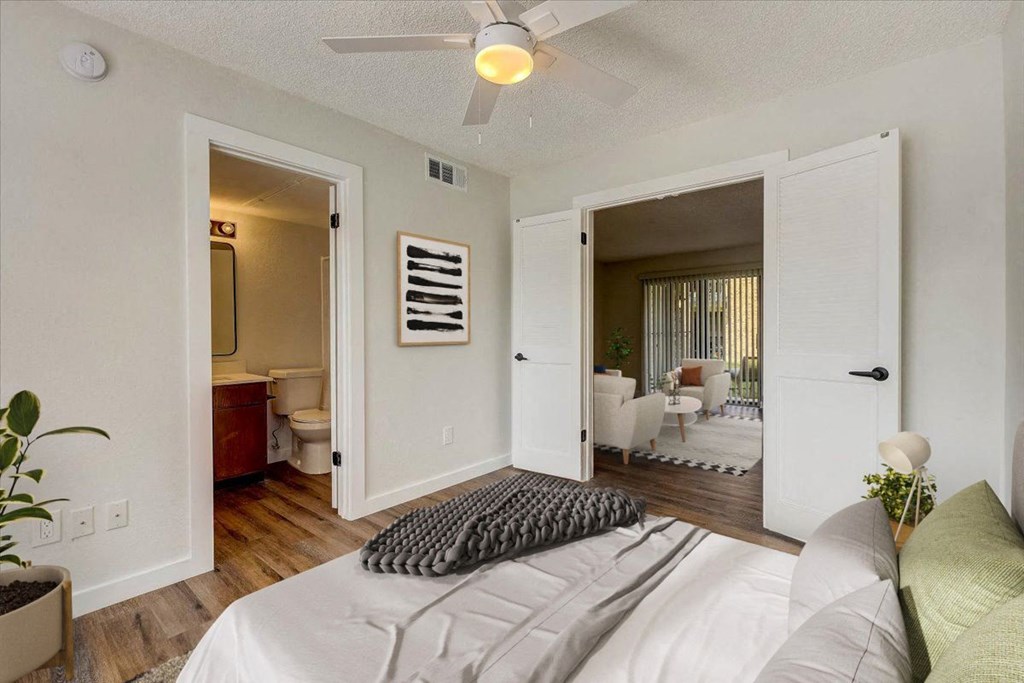a bedroom with a bed and a ceiling fan