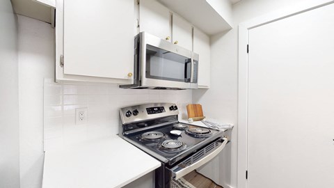 a small kitchen with a stove and a microwave