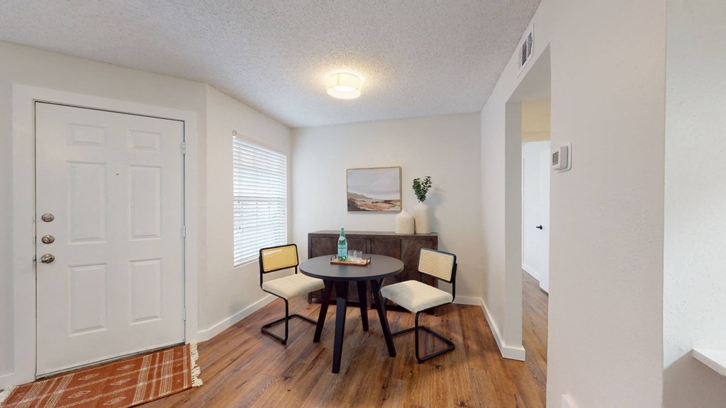 a dining room with a table and chairs