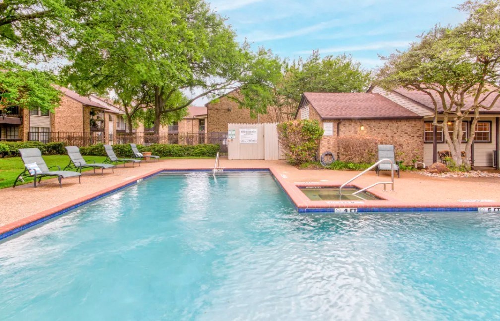 a swimming pool with a house in the background